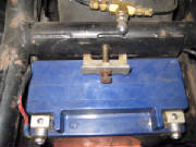 FXR battery hold down tab replaces OE #66183-82
